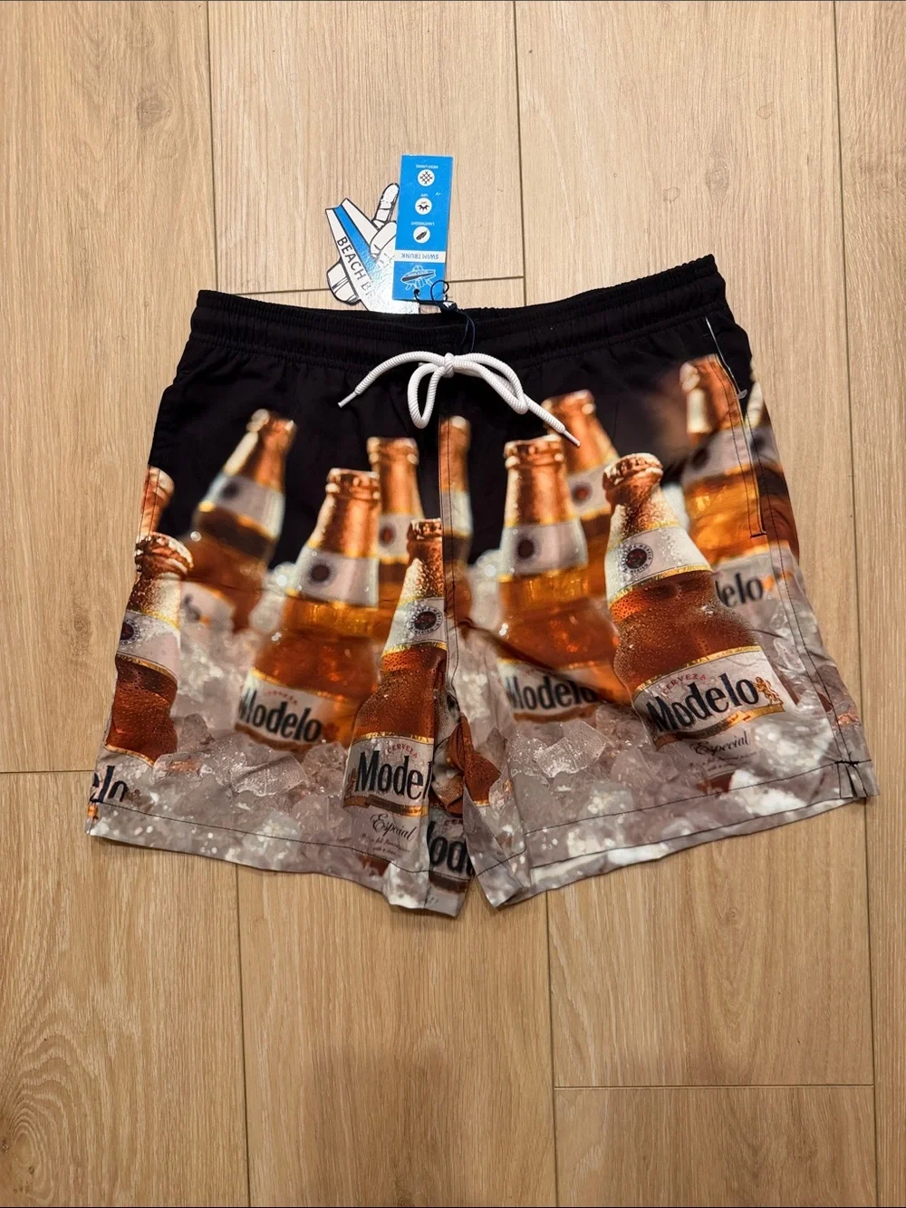 Modelo Bottle Print Men’s Swim Trunks in Black and Amber